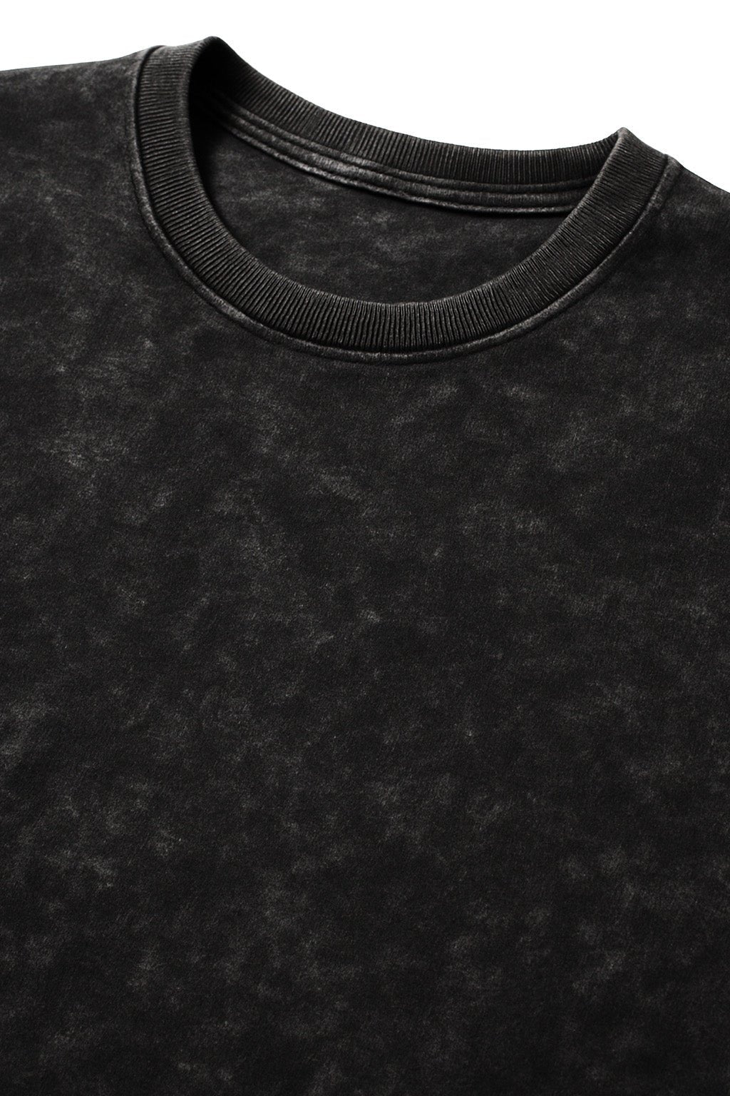 Close-up of the neckline of a black acid wash oversized t-shirt made from 240 GSM French terry fabric