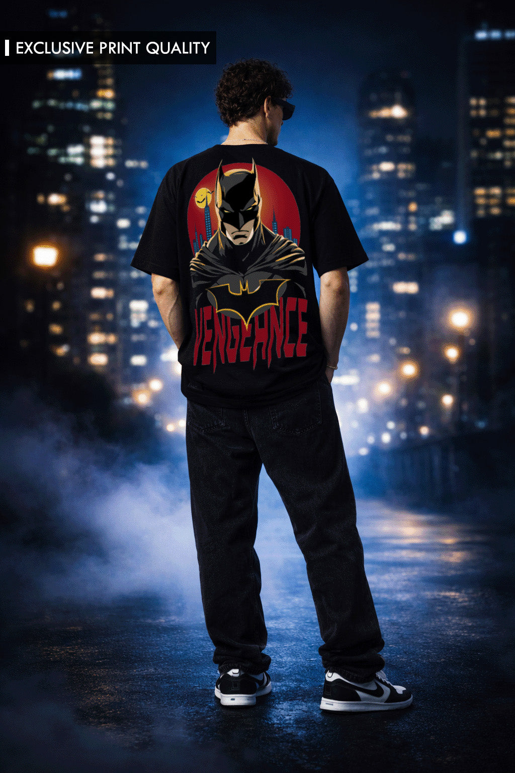 Person wearing a t-shirt with a superhero design in an urban night setting