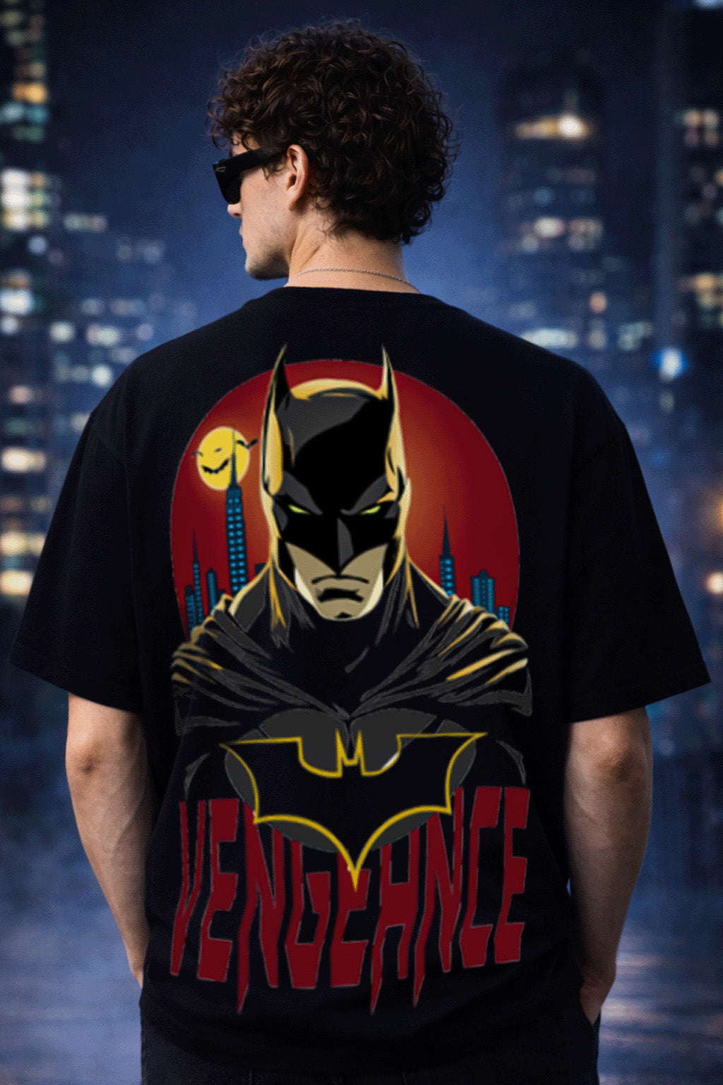 Person wearing a black t-shirt with a superhero design and 'Vengeance' text, standing against a cityscape background.