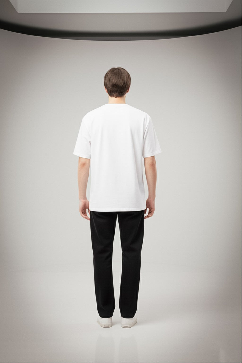 Back view of oversized white cotton t-shirt for men and women showing relaxed fit and minimal plain back design