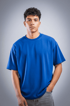 Person wearing a blue t-shirt against a gray background