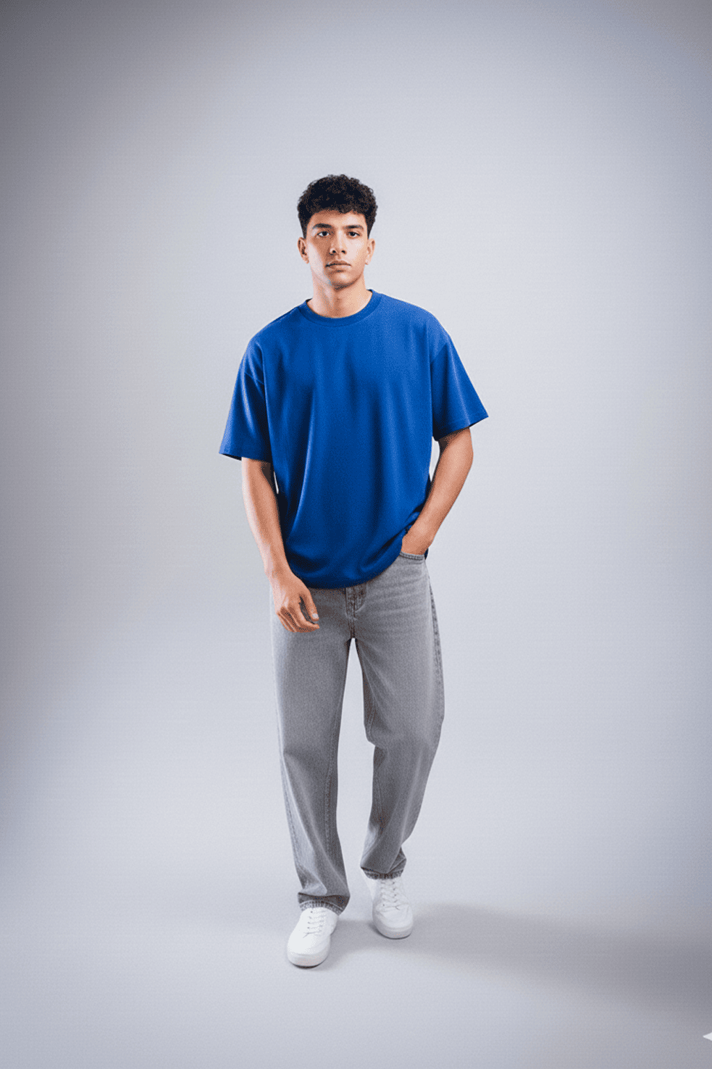 Person wearing a blue t-shirt and gray pants on a plain background