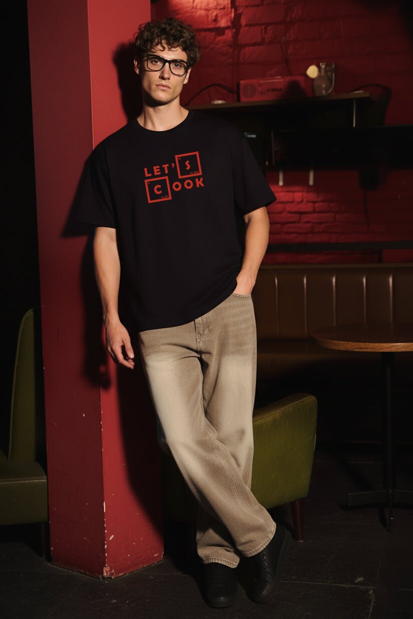 Front view of Breaking Bad “Let’s Cook” oversized black T-shirt with red chemical element style text