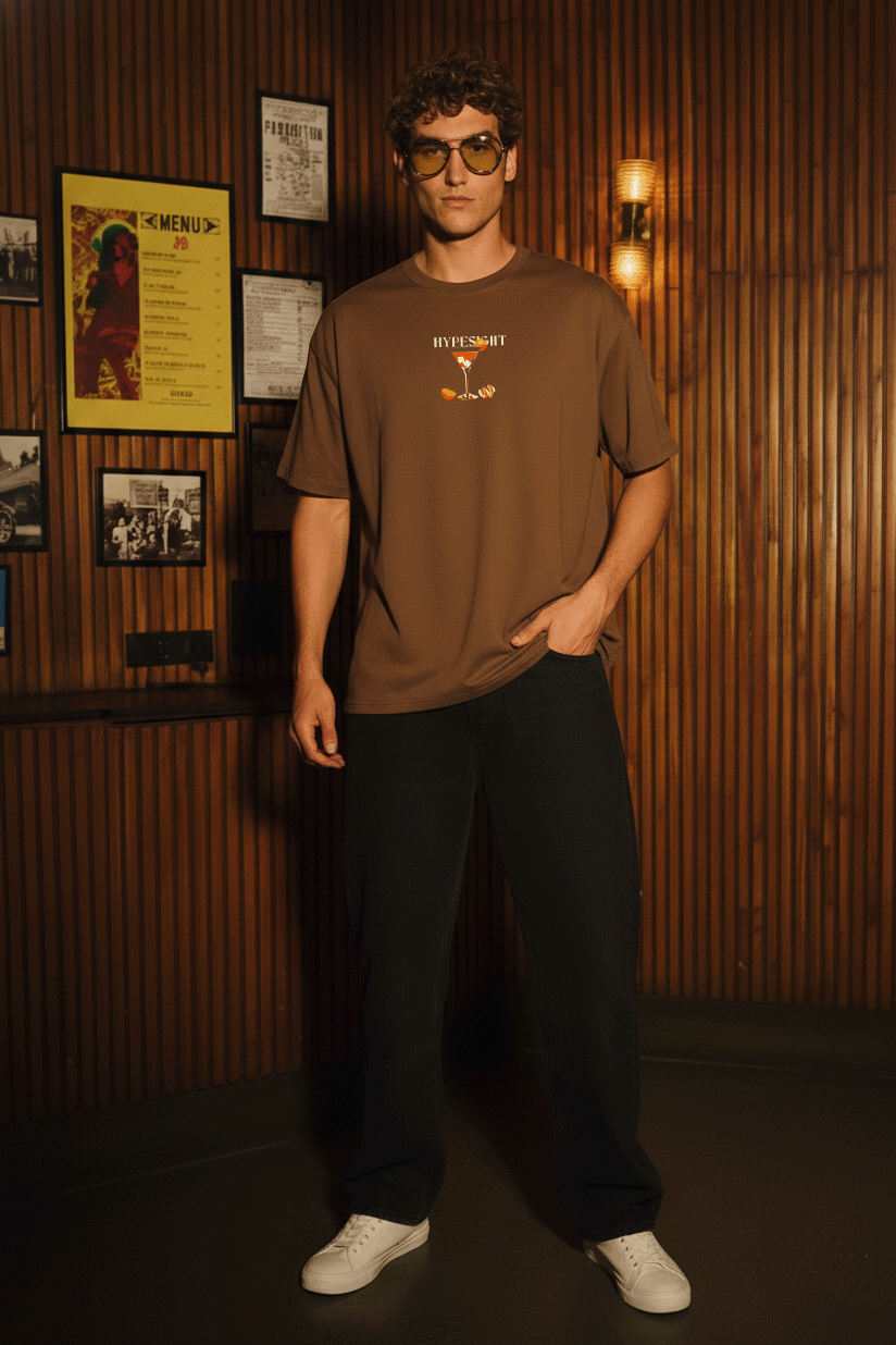 Front view of Brown Tequila Sunrise oversized cotton t-shirt with small cocktail glass graphic