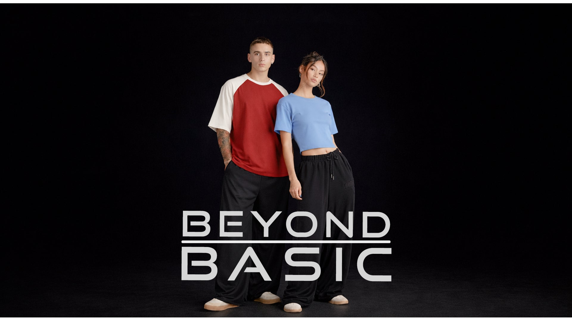 Two people standing side by side with 'Beyond Basic' text on a black background