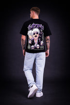 Person wearing a premium quality black t-shirt with a graphic design on the back against a dark background