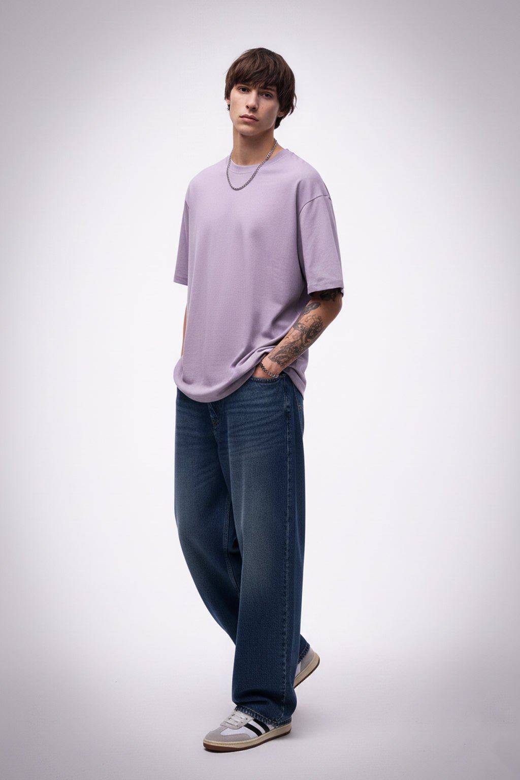 Person wearing a light purple t-shirt and blue jeans on a white background
