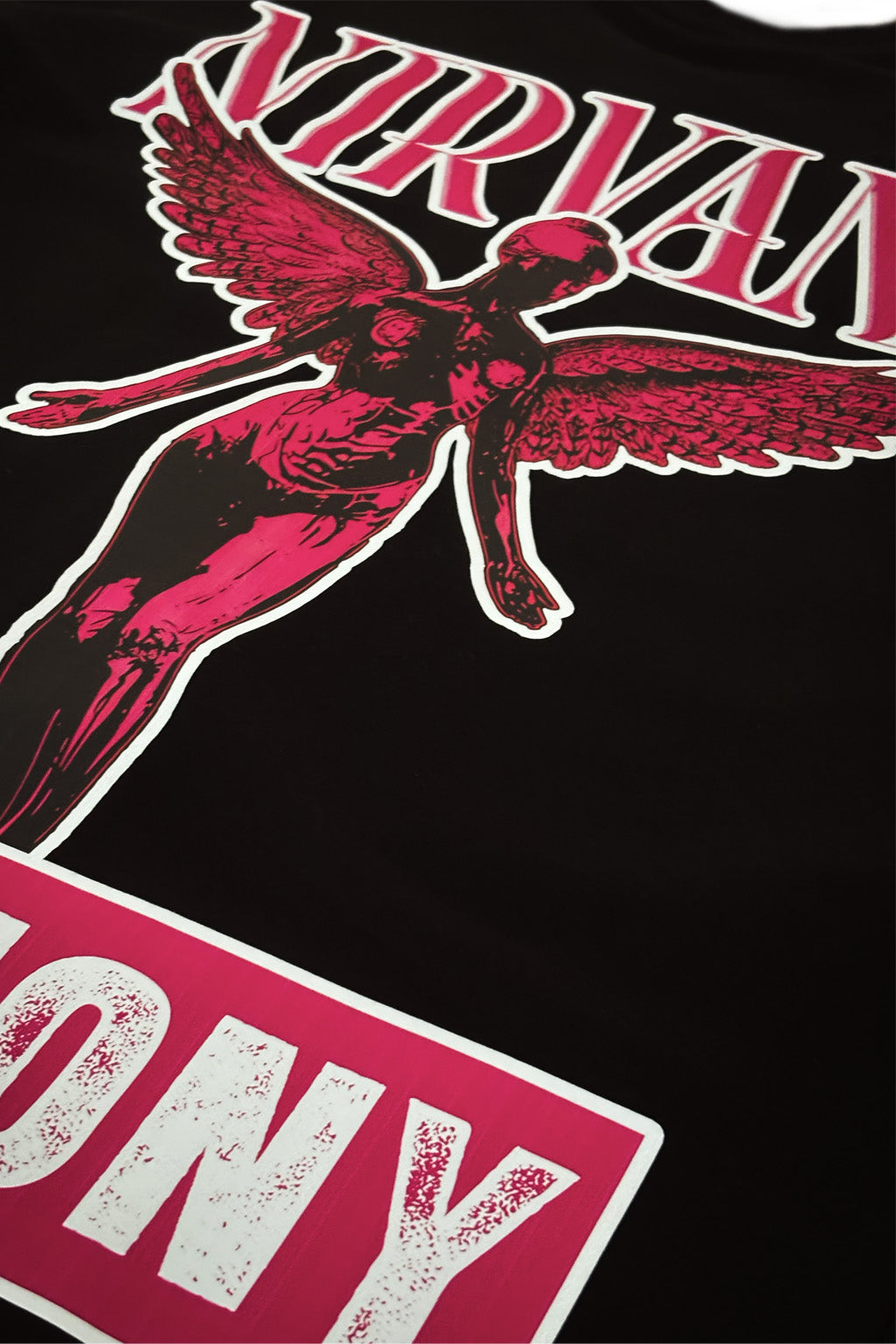 Black t-shirt with red and white graphic design featuring a winged figure and 'Nirvana' text.