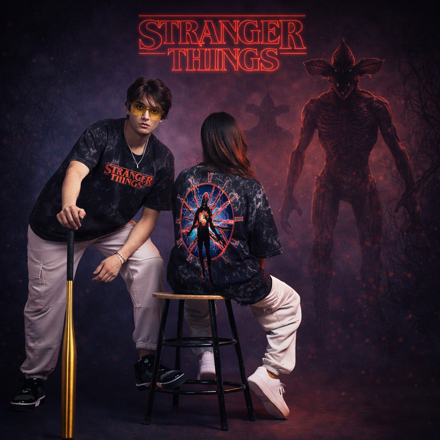 Two people wearing 'Stranger Things' themed shirts with a dark background featuring a creature.