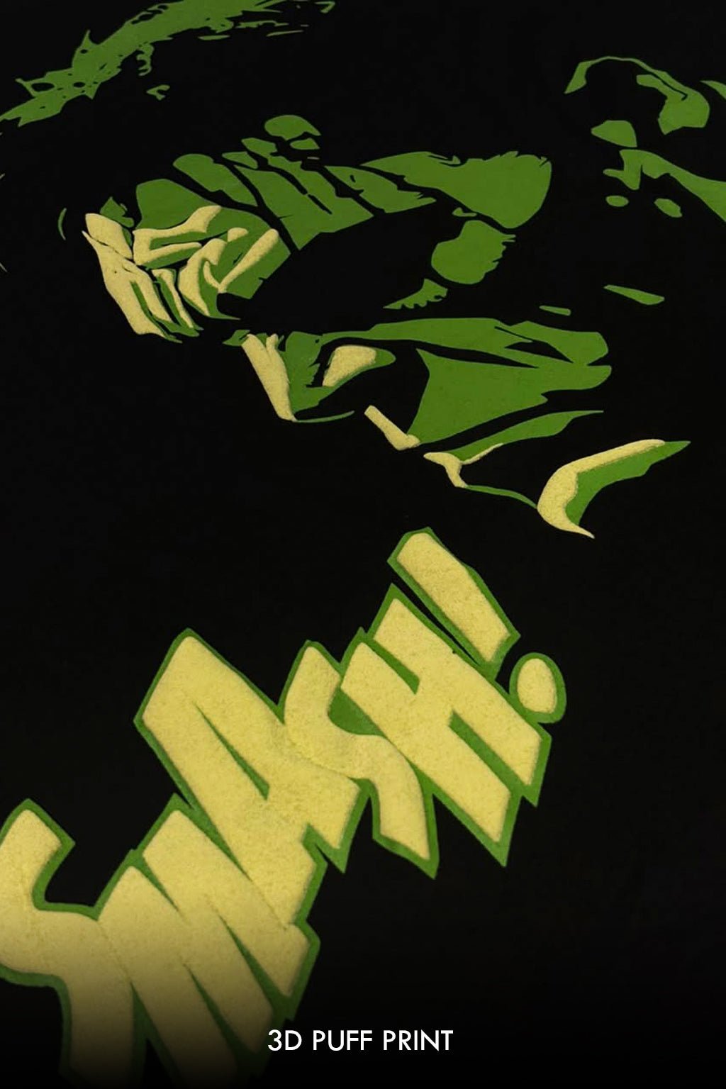 A close-up of a black garment featuring a green and pale yellow graphic print with the text '3D PUFF PRINT' at the bottom.