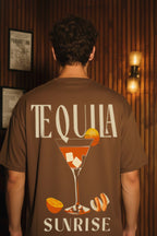 Back close-up view of Tequila Sunrise brown oversized T-shirt featuring cocktail glass and orange slice print